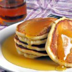Golden Cornmeal Pancakes Drizzled with Sweet Maple Syrup